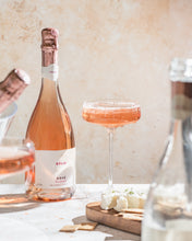 BOLLE Sparkling Rosé non-alcoholic wine in coupe glass with cheese pairing, award-winning alcohol-free champagne alternative