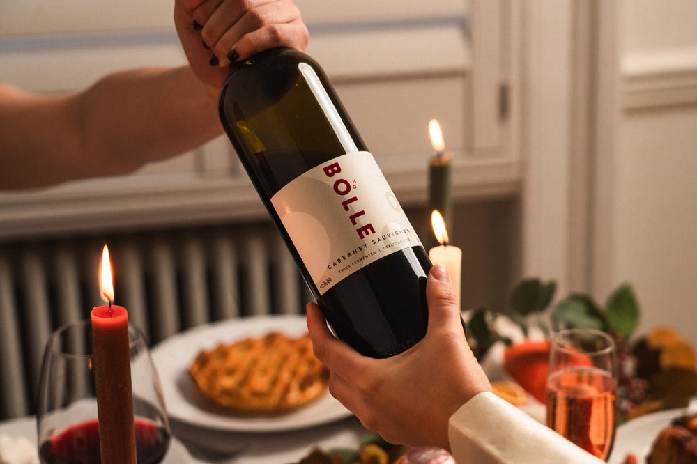 A bottle of BOLLE Cabernet Sauvignon held over the Thanksgiving table