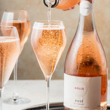 Pouring BOLLE Sparkling Rosé non-alcoholic wine into champagne flute, bubbles and effervescence of alcohol-free champagne