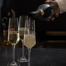 Pouring BOLLE Grand Reserve lees-aged non-alcoholic sparkling wine into champagne flutes, premium alcohol-free wine with bubbles